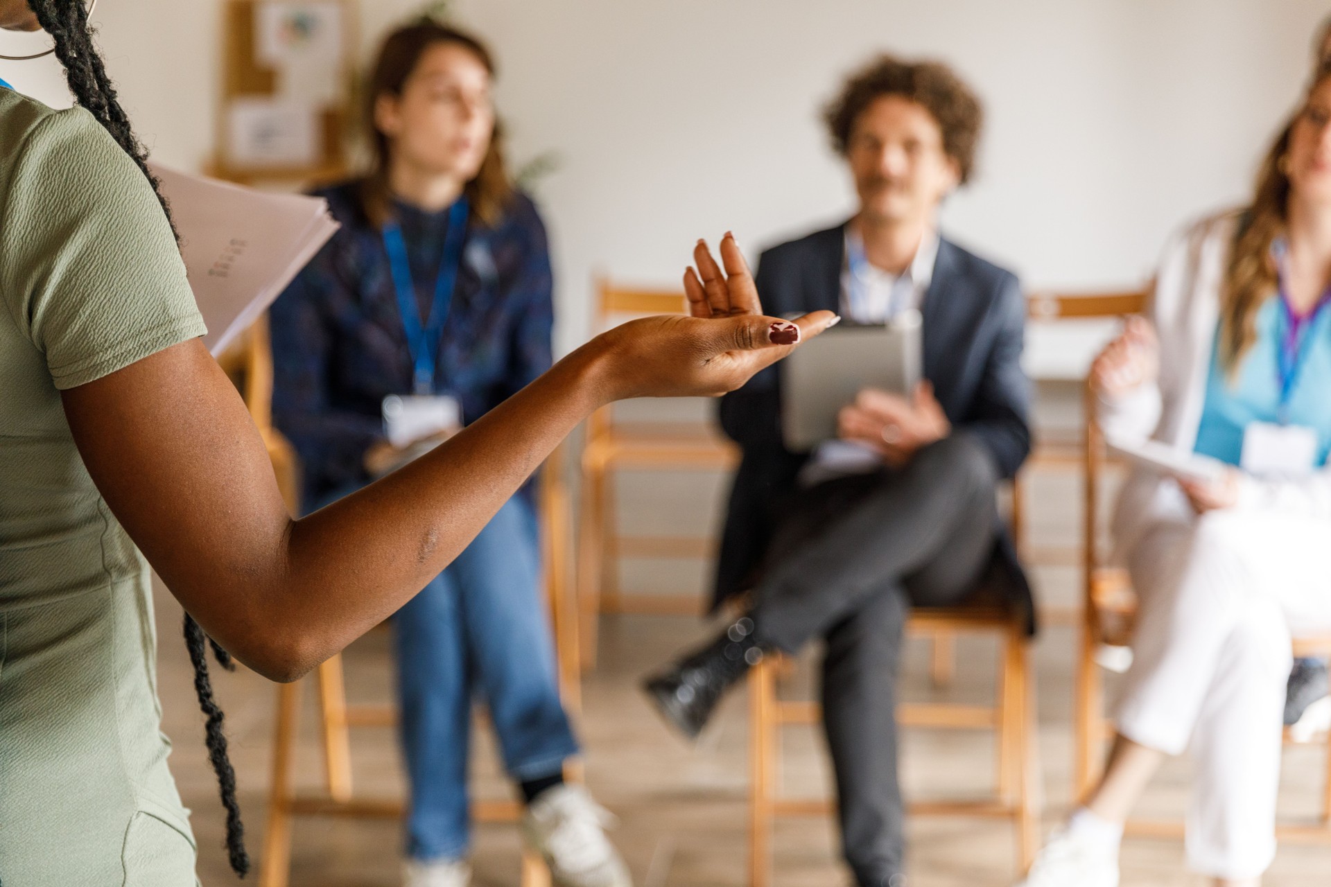 Businesswoman holding a seminar for a group of diverse business people